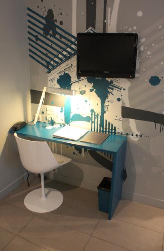 an office with a blue desk with a computer at Arc de Triomphe Etoile in Paris