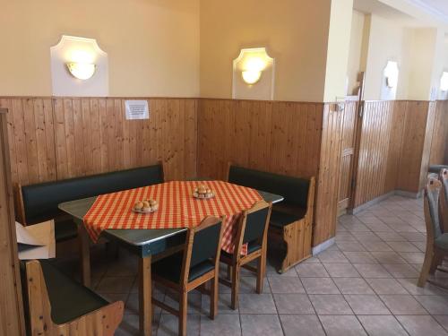 a dining room with a table and chairs at Kék Lagúna Panzió in Dombrád