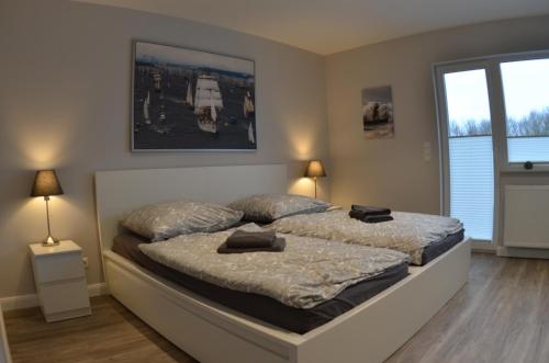 a bedroom with a large bed with two pillows on it at Ferienhaus Rosi in Kiel
