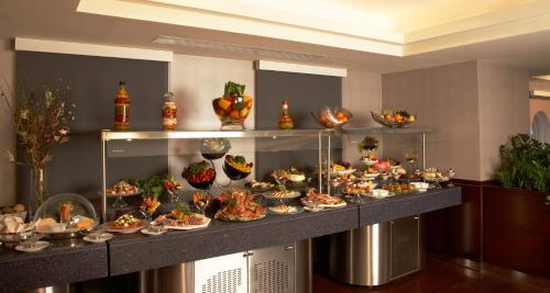 a buffet of food on a table in a room at Al Manzel Hotel Apartments in Abu Dhabi