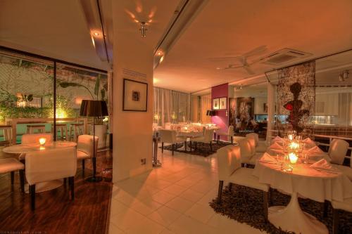a dining room with white tables and white chairs at Bab Hotel in Marrakech