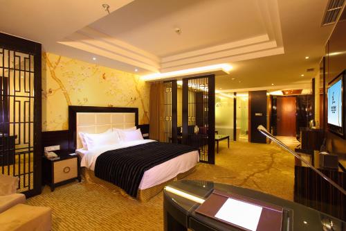 a bedroom with a bed and a tv in a room at Beijing Kai Sheng Xing Feng International Hotel in Shunyi