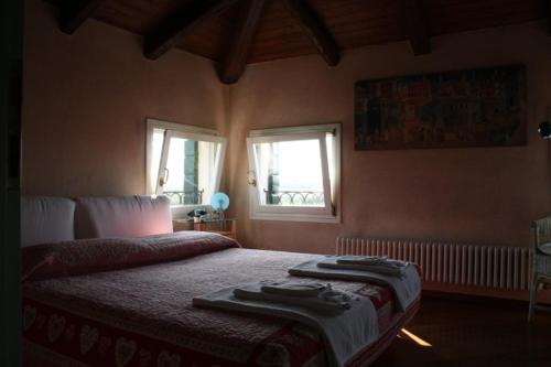 a bedroom with a bed with two pillows on it at Ca' Torcello in Venice