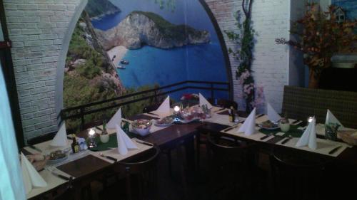 a table with white paper boats on it with a mural at Schuttershof Heerlen - Adults Only in Heerlen