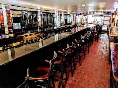 a bar with a row of empty chairs and tables at Chelsea Pub and Inn in Atlantic City