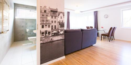 a bathroom with a wall mural of a city at Apartment Milena in Gdańsk