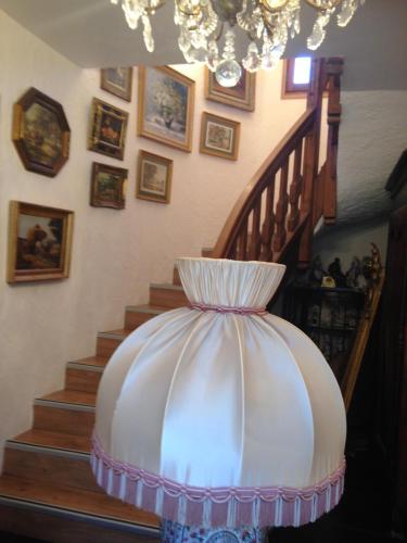 a room with a staircase with a lamp with a lamp shade at Hotel bar b'rock in Saint-Martin-sous-Vigouroux