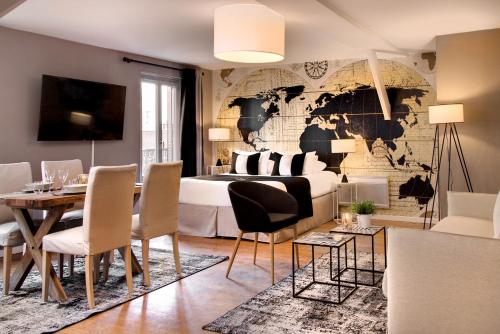 a bedroom with a map of the world on a wall at Hôtel des Ducs in Dijon