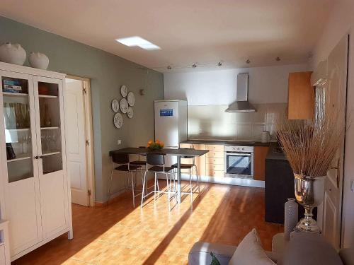 a kitchen with a table and chairs in a room at Mirador del valle in Agaete