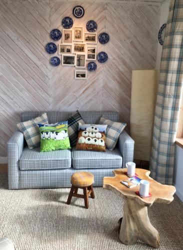 a living room with a couch and a table at The Stroops in Helmsdale