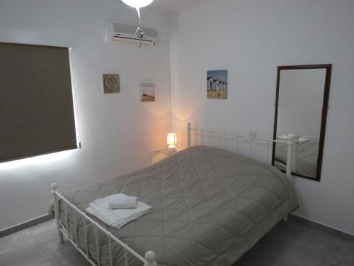 a bedroom with a bed and a large window at Adonis Apartment in Paphos