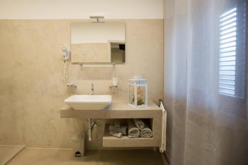 a bathroom with a sink and a mirror at La Magione in Serravalle Pistoiese