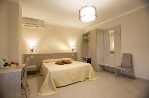 a bedroom with a bed and a desk and a mirror at La Magione in Serravalle Pistoiese