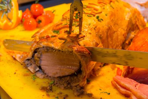 a knife cutting into a piece of food on a plate at Murphy's Hotel in Tobercurry