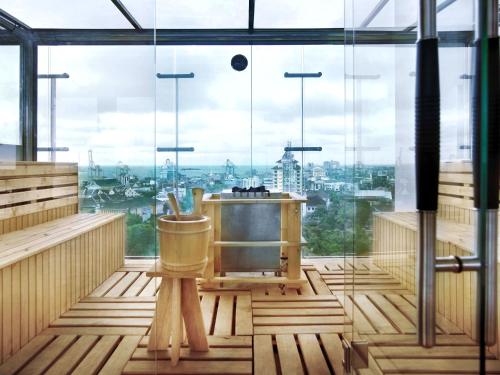 a room with a view of a city through a window at Aston Makassar Hotel & Convention Center in Makassar