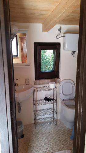 a bathroom with a sink and a toilet and a window at Agriturismo La Torre Rossa in Itri