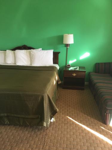 A bed or beds in a room at Travelers Inn Olney
