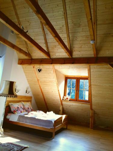 a bedroom with a bed in a wooden house at Sielsko-Anielsko centrum in Kazimierz Dolny