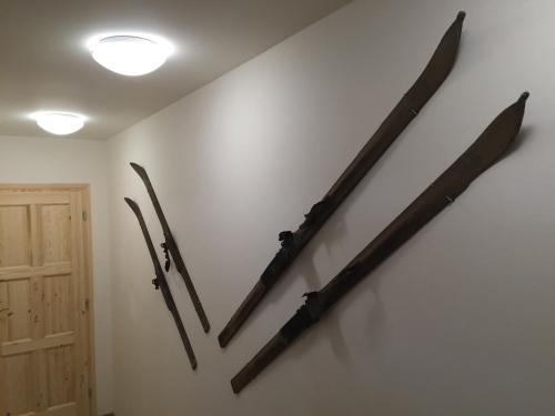 three weapons hanging on a wall next to a door at Apartmány Sportrelax in Albrechtice v Jizerských horách