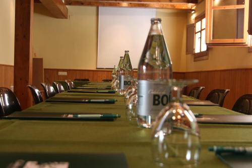 a conference room with a long table with bottles on it at Hotel Manantial in Caldes de Boi