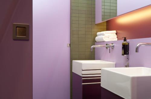 a bathroom with a sink and a mirror at Hôtel Montmorency & Spa in Carcassonne