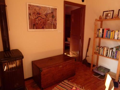 a room with a wooden table and a book shelf at La Canàoula in Bobbio Pellice