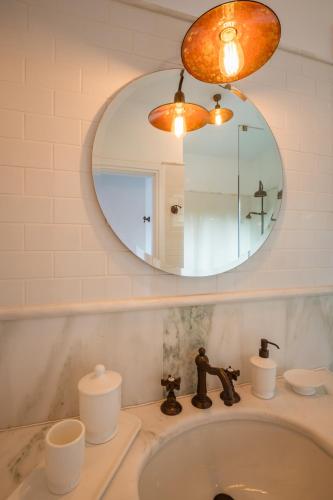 a bathroom with a sink and a mirror at North Point Houses in Fiskardho