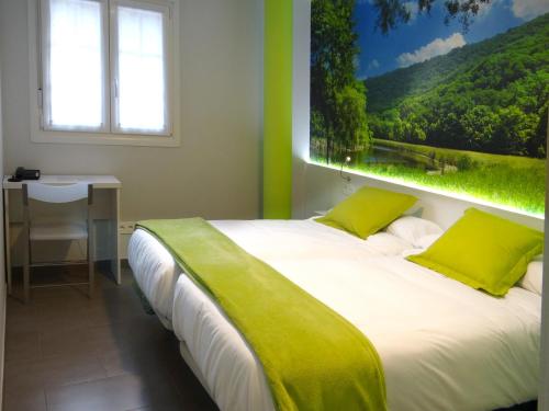 a bedroom with a bed with a large window at Bekale in Ea