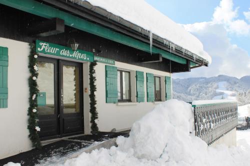 a pile of snow in front of a building at Chalet Fleur des Alpes 1 in Les Gets