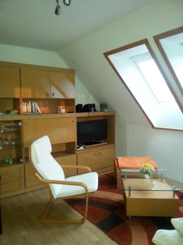 a living room with a white chair and a skylight at "Heiterer Blick" in Annaberg-Buchholz