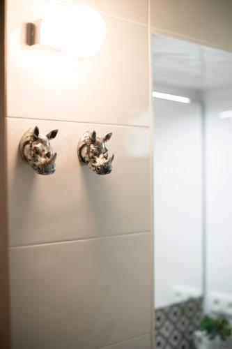 a bathroom with two gargoyles on the wall at Casa 2Mariposas in Mijas