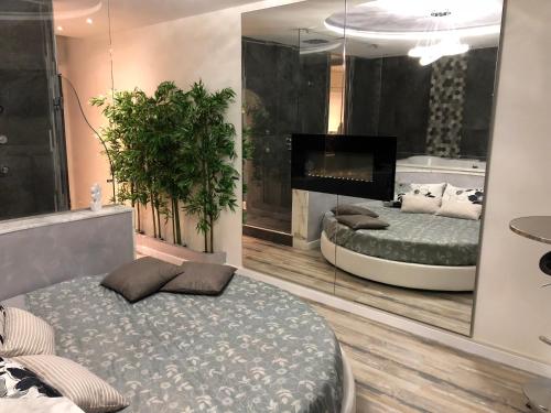 a bedroom with two beds and a large mirror at Assisi Luxury SPA Suite in Assisi