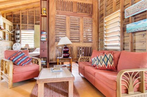 a living room with a couch and a table at Amanda's Place Casa Amancer - sea view, pool and tropical garden in Caye Caulker