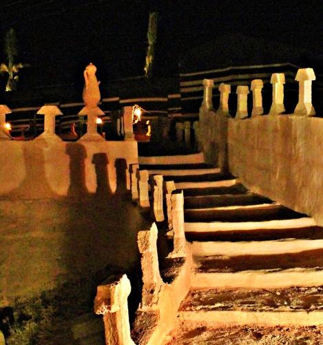 a set of stone stairs with a fence at night at Seven Wonders Bedouin Camp in Wadi Musa