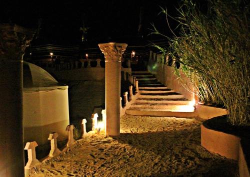 a set of stairs with candles in the dark at Seven Wonders Bedouin Camp in Wadi Musa