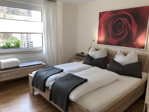 ein Schlafzimmer mit einem Bett mit einem roten Gemälde an der Wand in der Unterkunft Dolcevita in Bad Bertrich