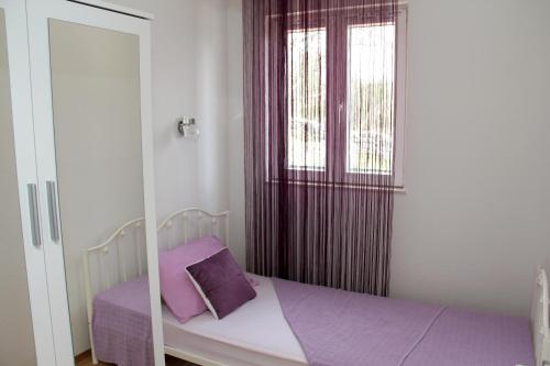 Postel nebo postele na pokoji v ubytování Apartmani Corleone