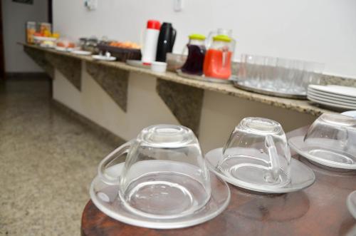 two empty glasses sitting on top of a table at Caminho da Costa Verde in Itaguaí