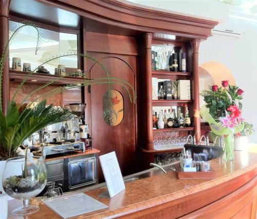 a kitchen with a bar with a counter with flowers at Affittacamere Parella in Turin