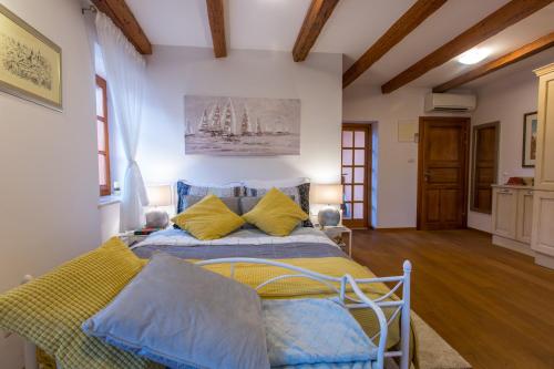 a bedroom with a bed with blue and yellow pillows at Villa Lucija Vodice in Vodice