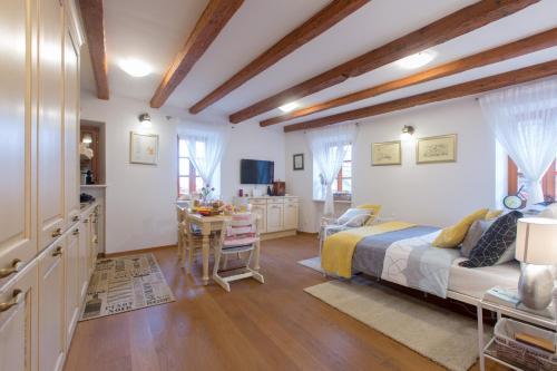 a bedroom with a bed and a desk and a kitchen at Villa Lucija Vodice in Vodice