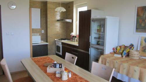 a kitchen with a table and a dining room at Ubytování u Macochy in Vilémovice