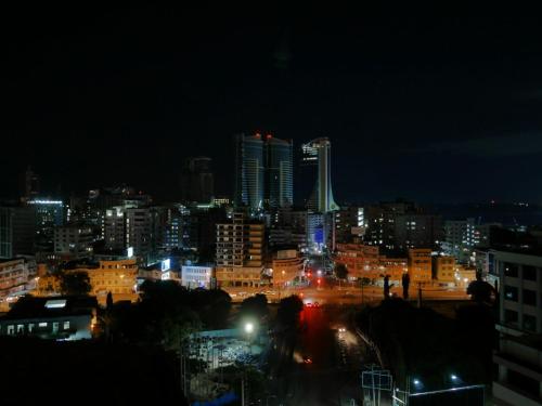 a view of a city at night with lights at Chelsea Hotel in Dar es Salaam
