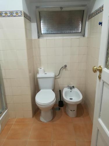 a small bathroom with a toilet and a sink at 100% Lisbon in Lisbon