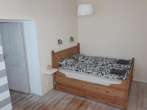 a bedroom with a bed with a black and white comforter at Apartament Zwycięstwa in Gliwice