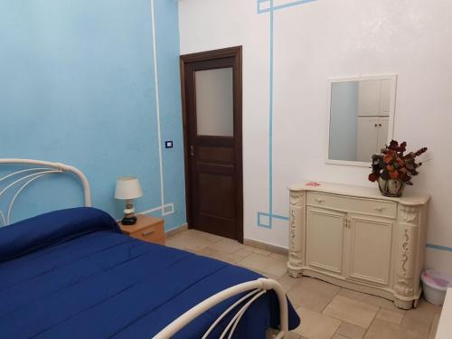 a blue bedroom with a bed and a mirror at Pelù il marinaio in Palermo