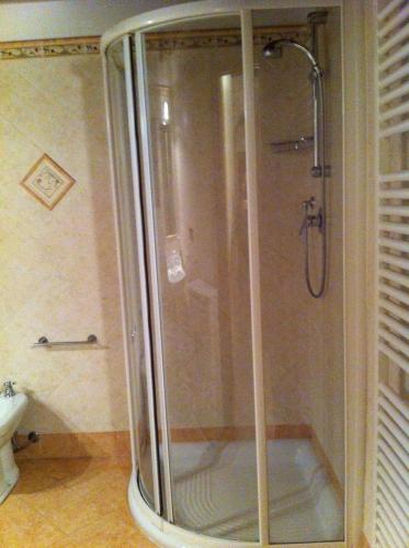 a shower with a glass door in a bathroom at Residence LA FORTUNA in Fano