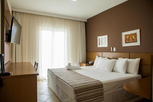 Llit o llits en una habitació de Mundial Parque Hotel