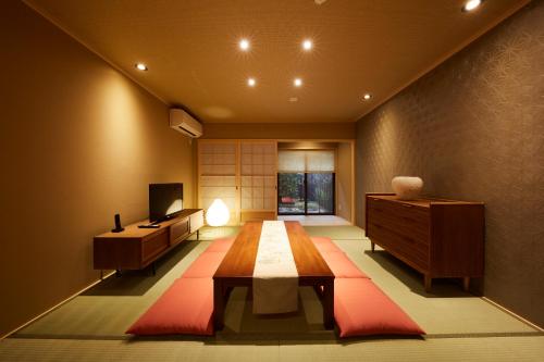 京都市にある鈴 宮川町 椿のテーブル、デスク、テレビが備わる客室です。