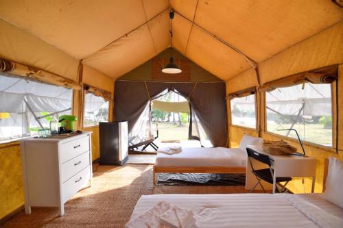 a bedroom with two beds in a tent at Naivacha Tent Koh Mak in Ko Mak
